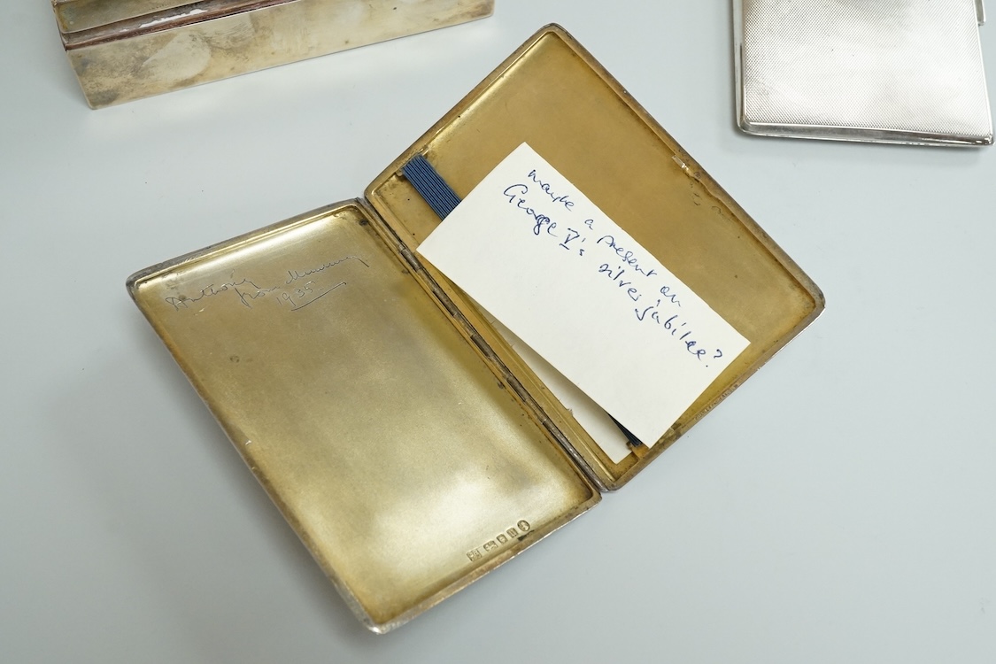 An engine turned silver rectangular cigarette box, 14.1cm and two mid 20th century engine turned silver cigarette cases.